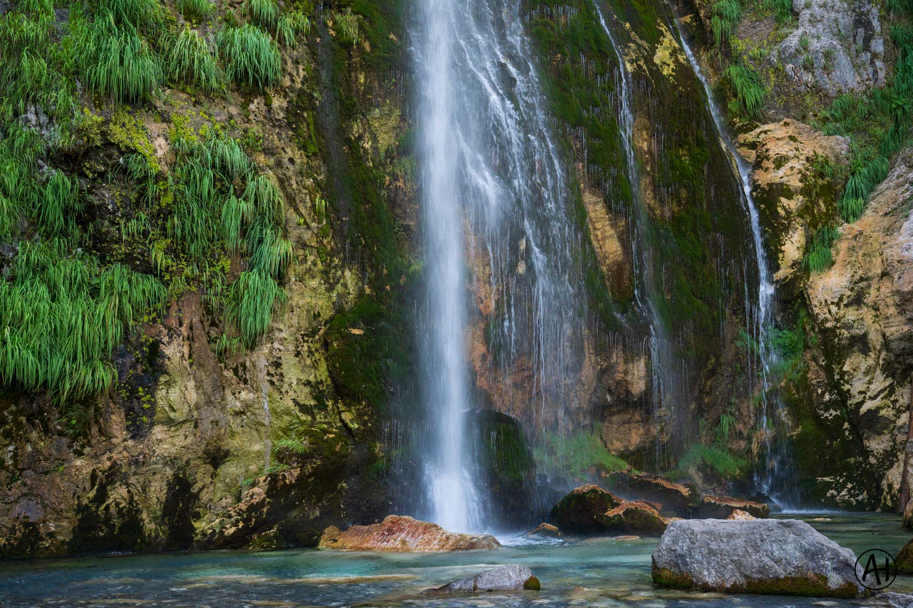 Water falling into a shaded rocky pool