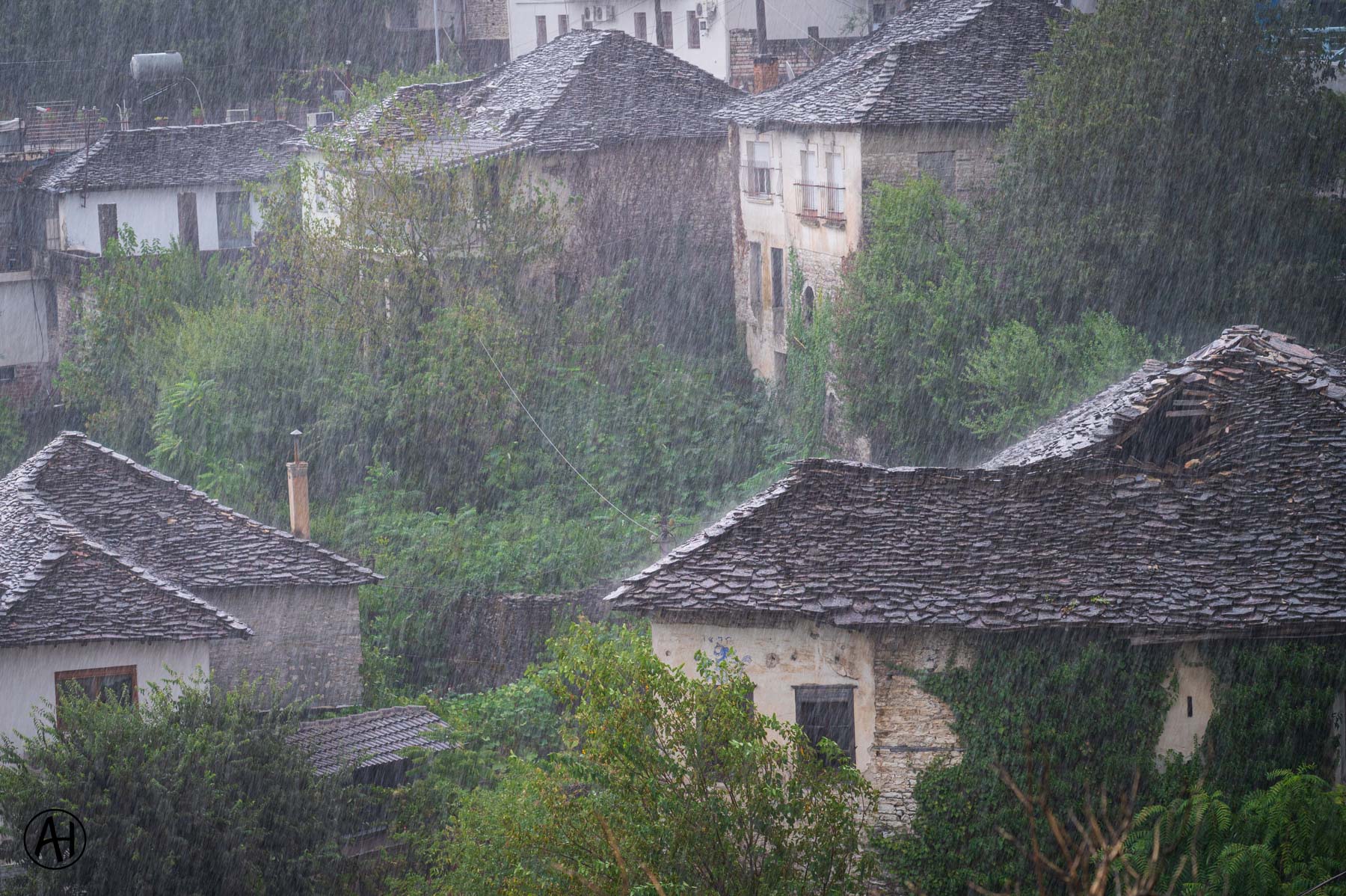 Rain falling over traditional stone rooftops
